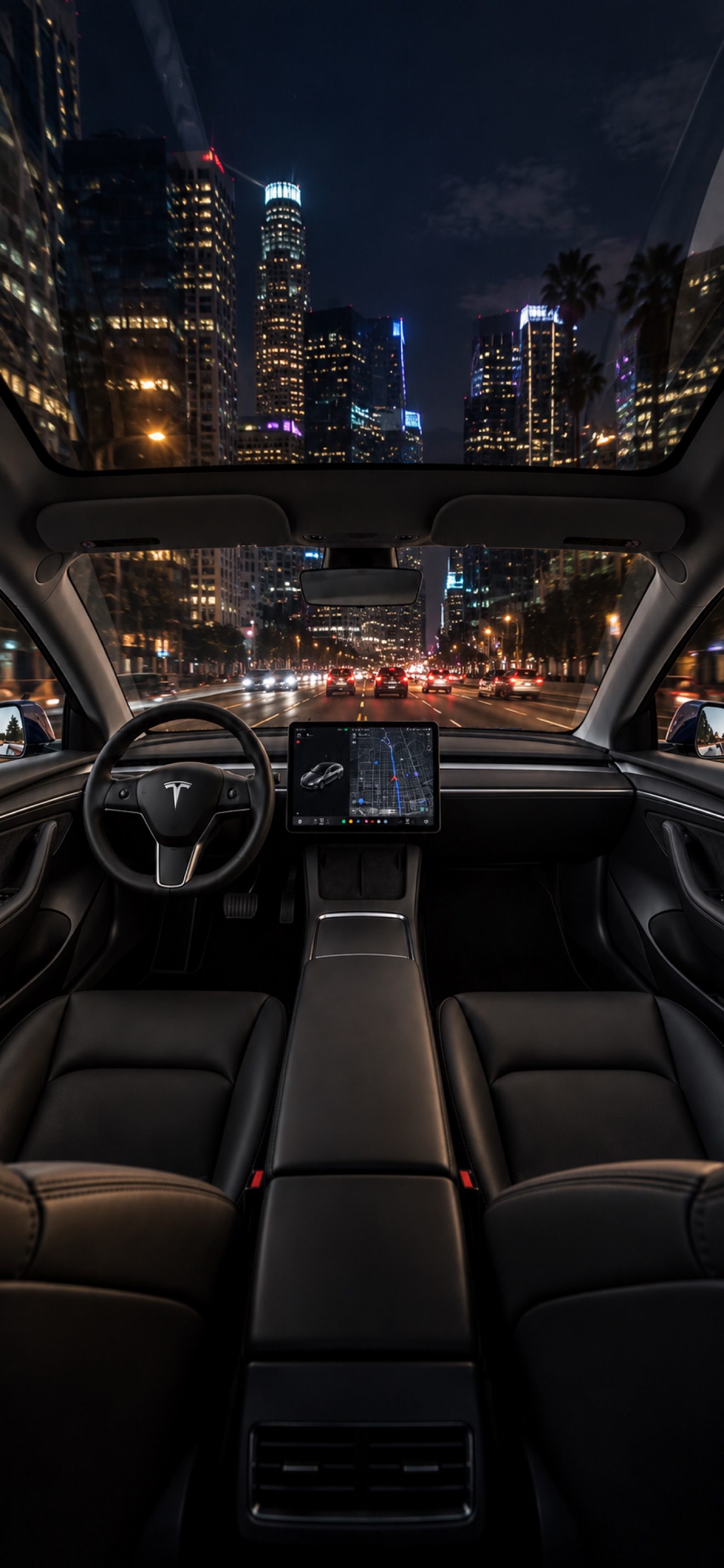 Inside the Model 3 at night, Los Angeles skyline through the windshield